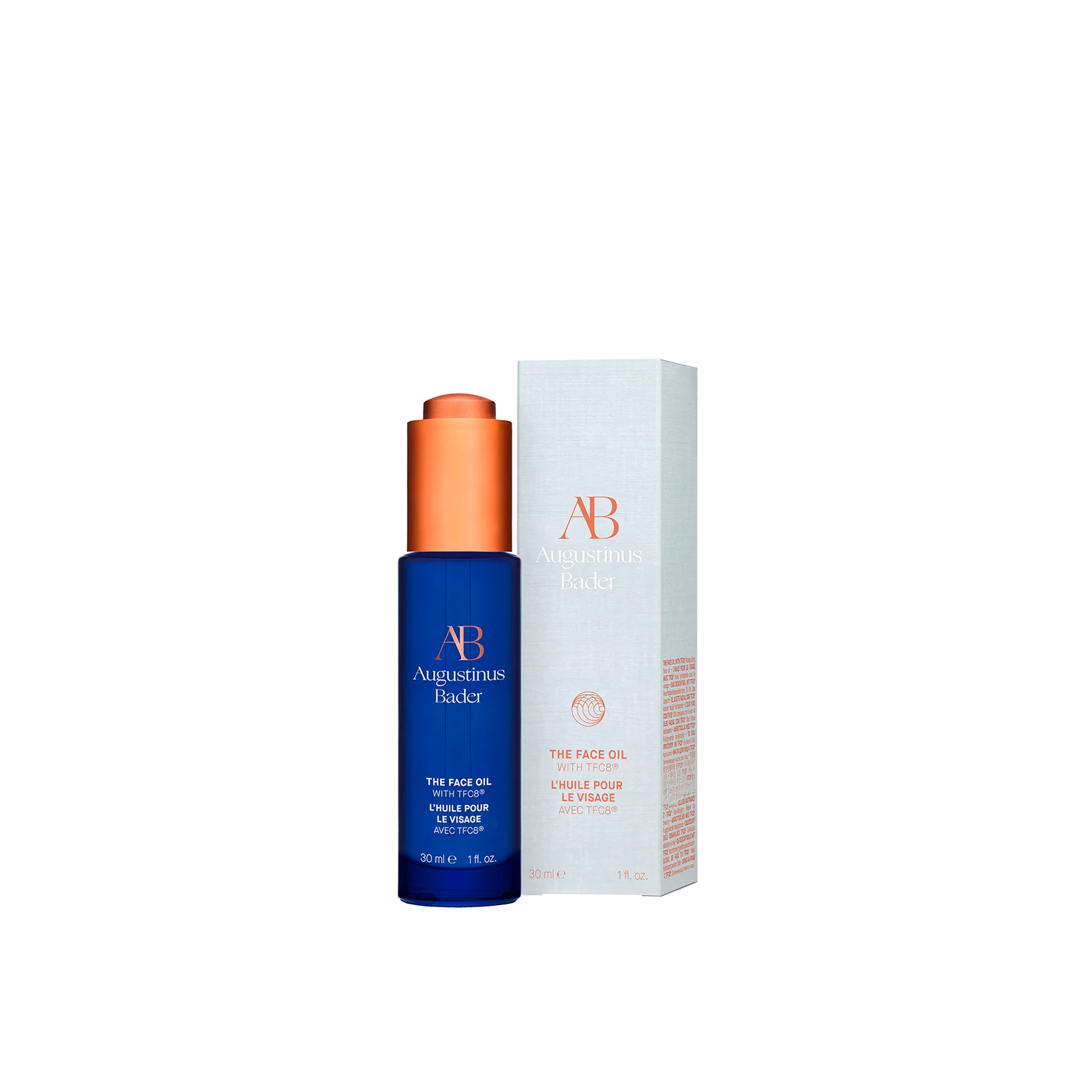 A bottle of Augustinus Bader The Face Oil next to the matching box it comes in.