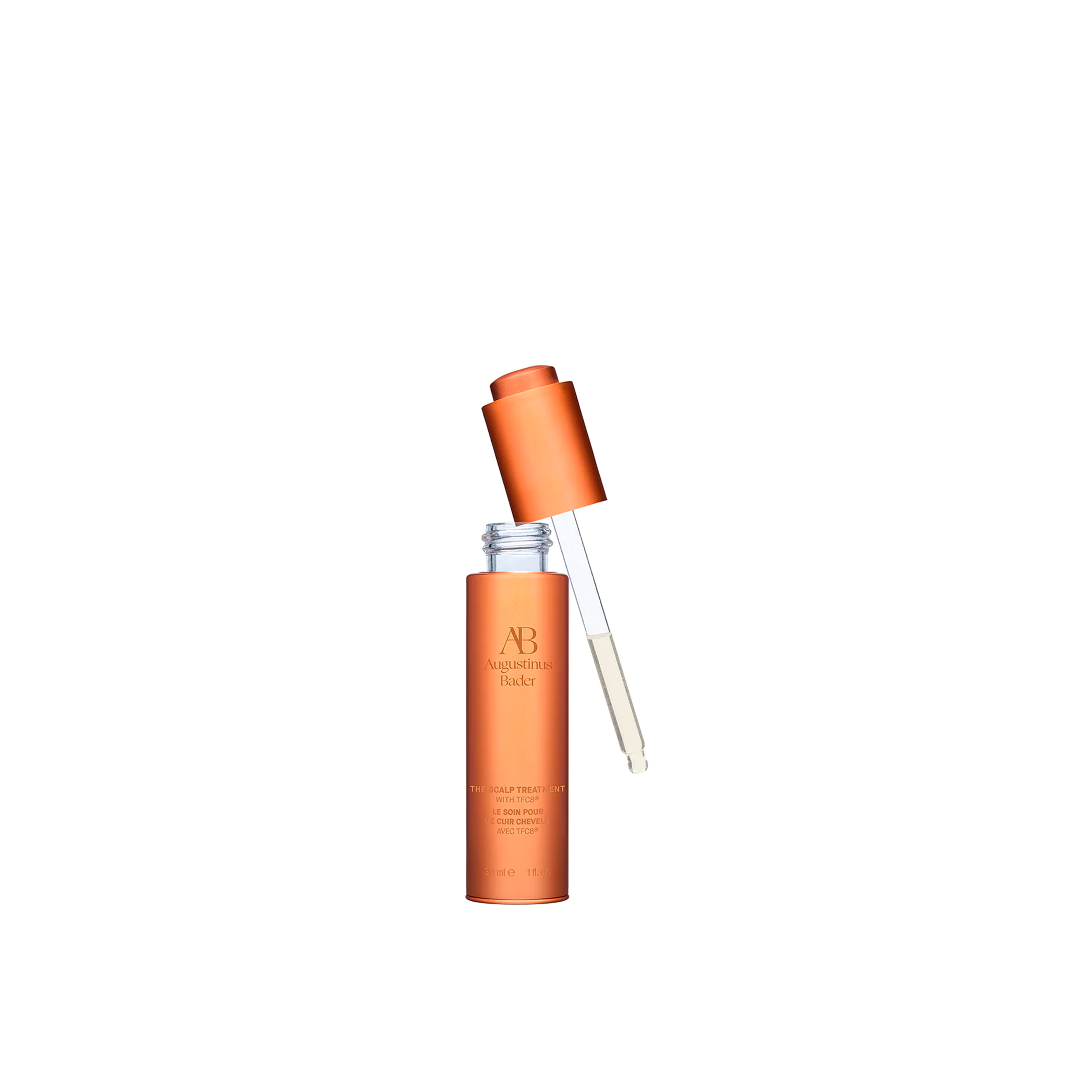 A bottle of Augustinus Bader The Scalp Treatment, showing the dropper when the lid is removed.