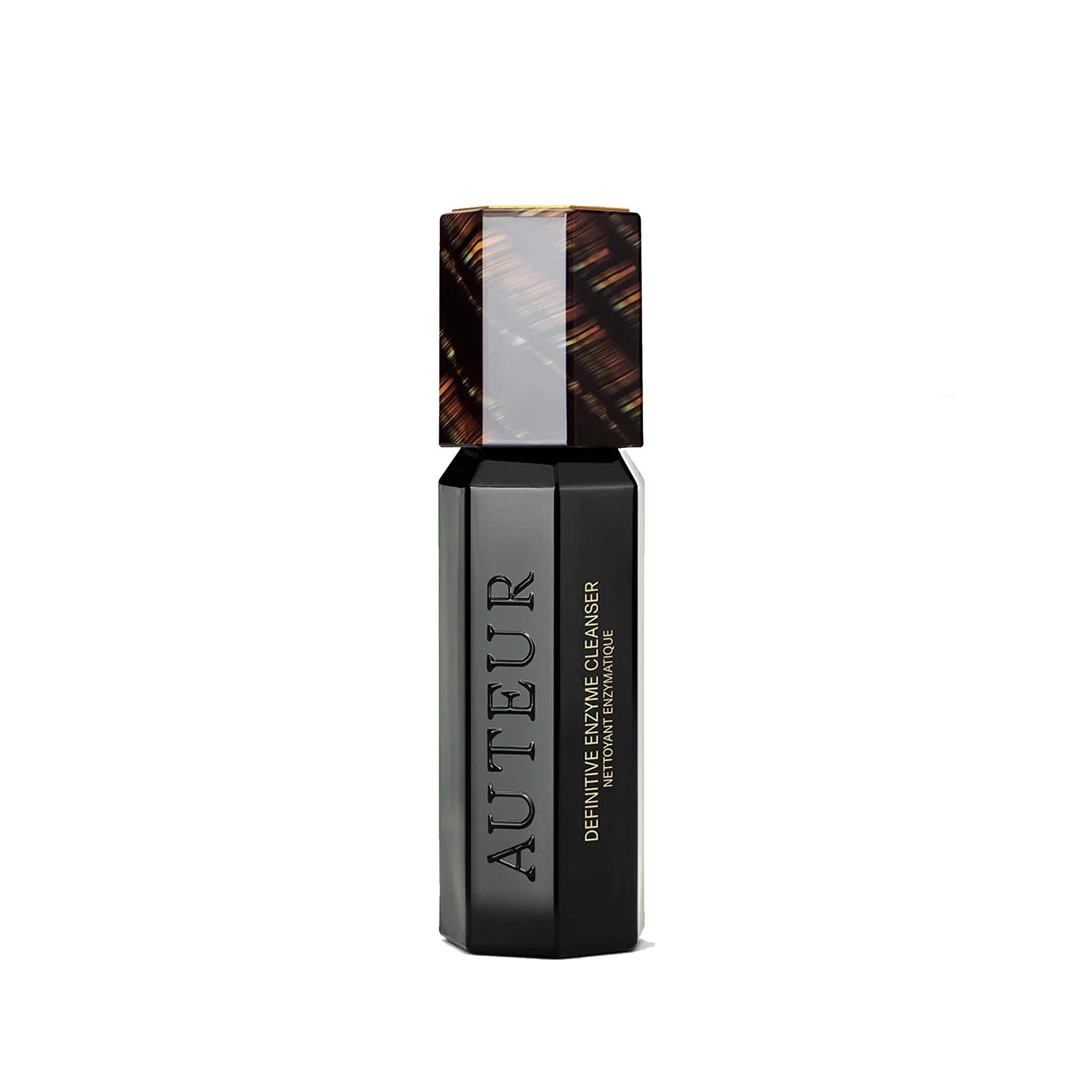 A bottle of Auteur Definitive Enzyme Cleanser with a dark liquid and a cap, on a white background.