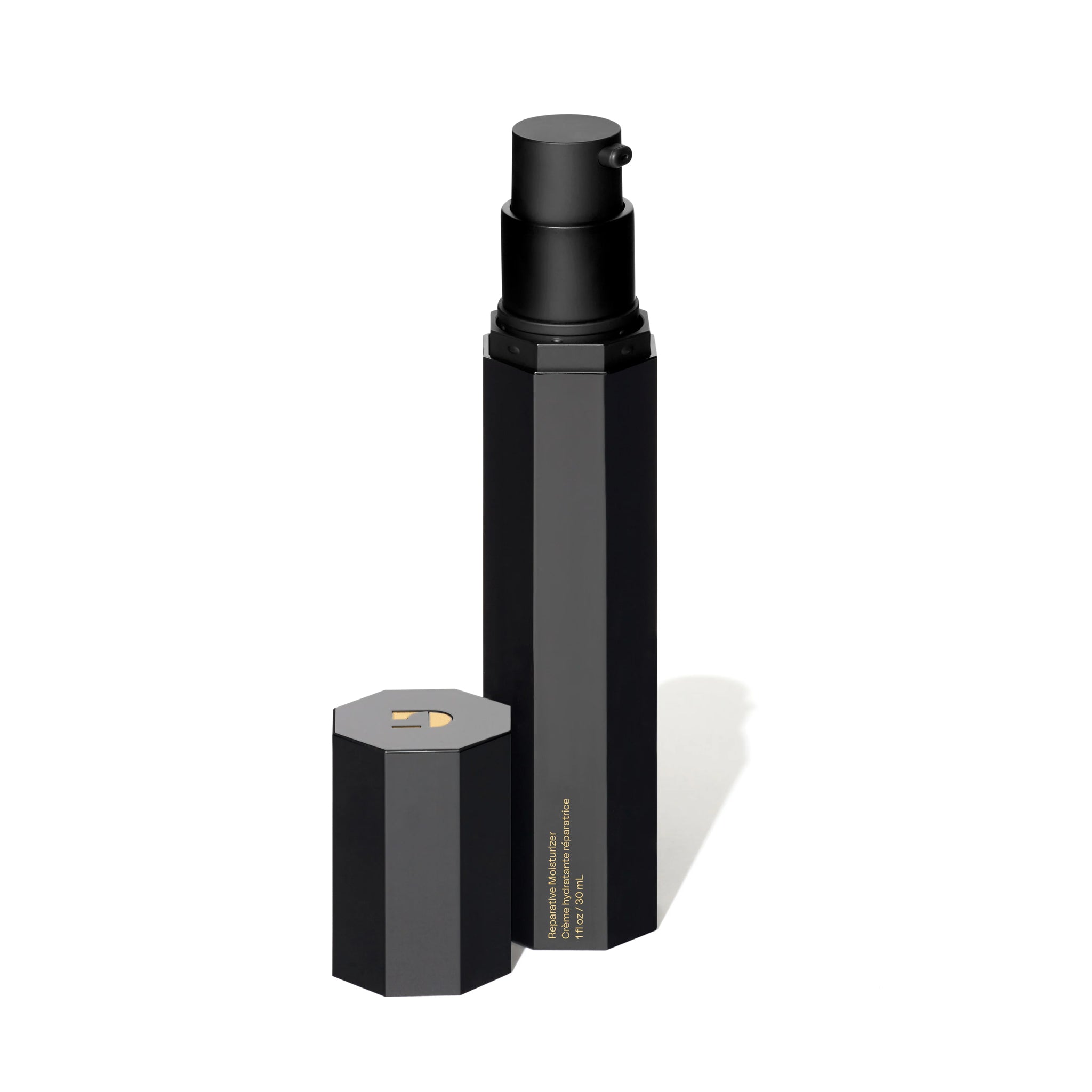 Black cosmetic bottle with hexagonal cap on a white background
