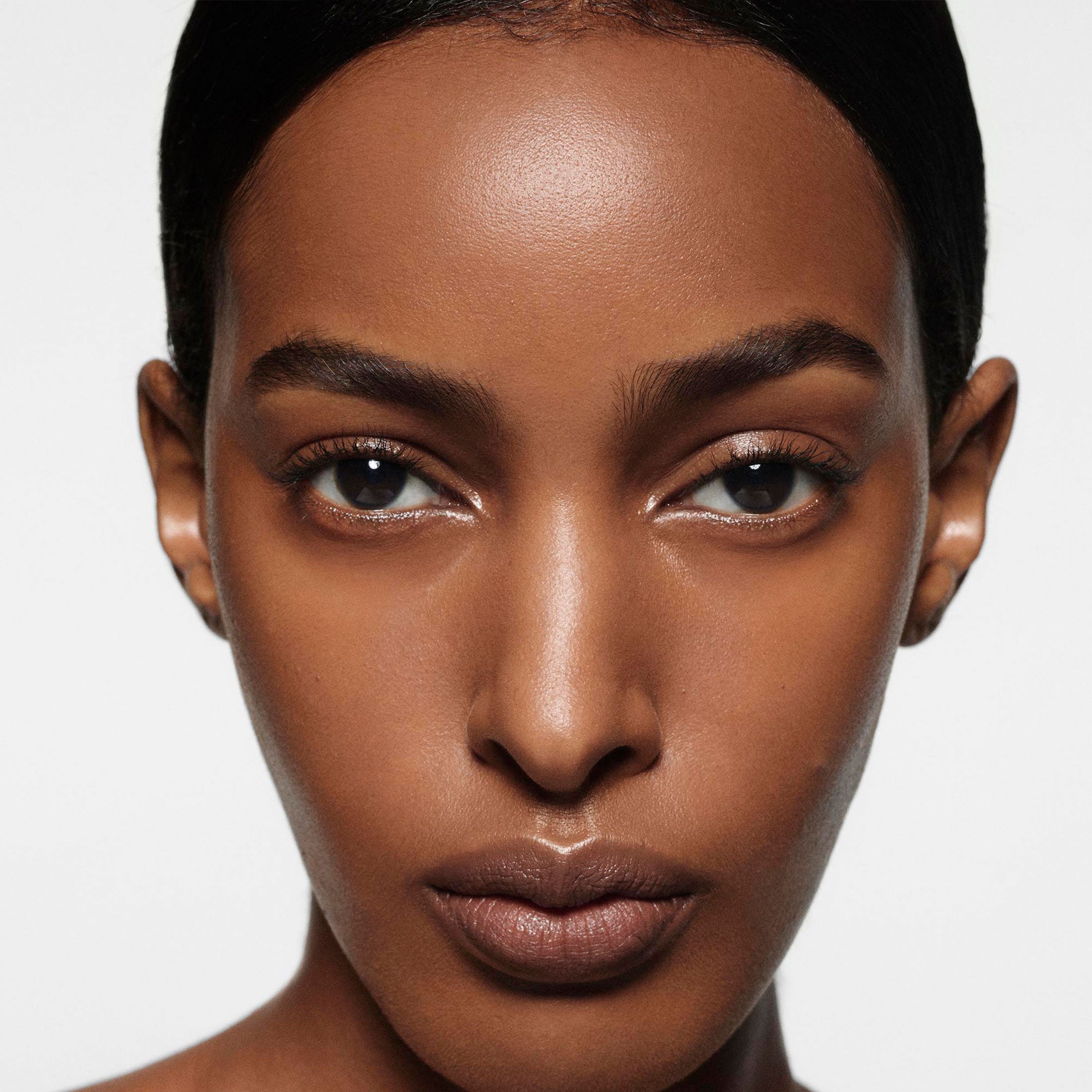 Close-up of a woman's face with a neutral background
