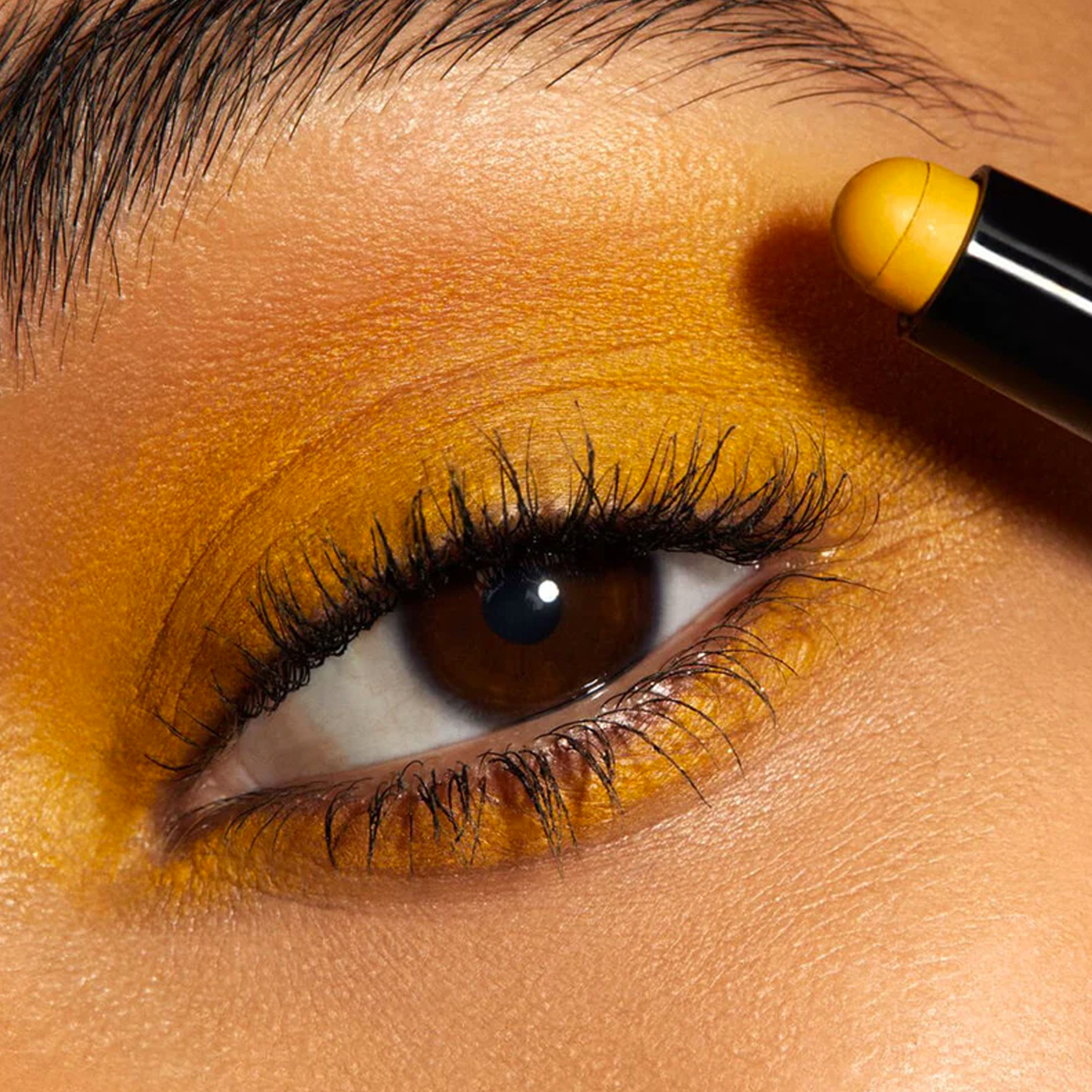 Close up of eyelid with yellow eyeshadow