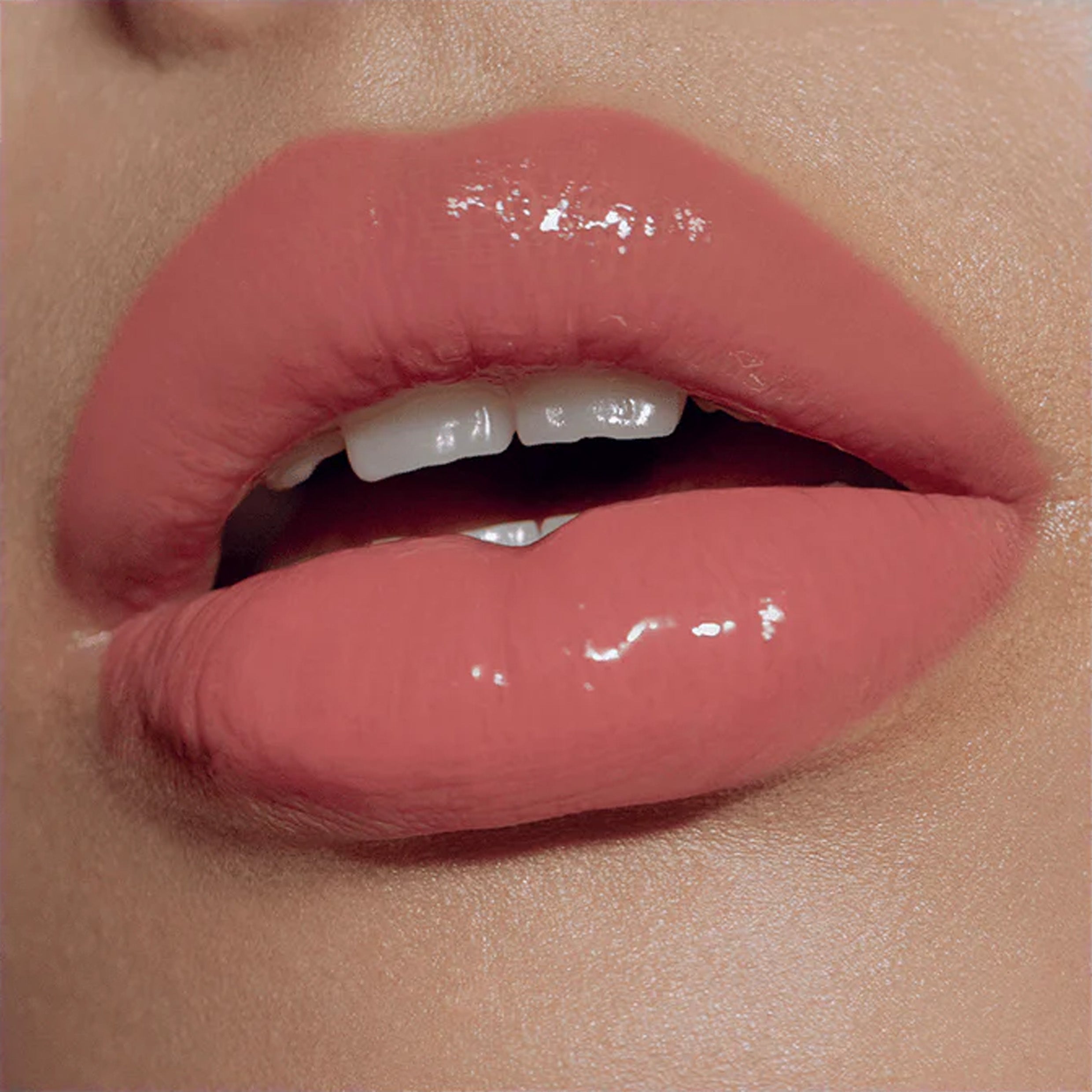 A close up image of lips wearing lipgloss
