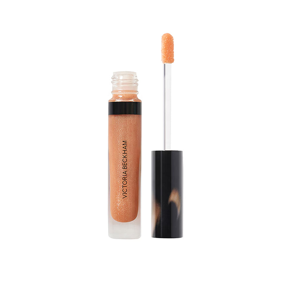 Victoria Beckham lip gloss with applicator on a white background
