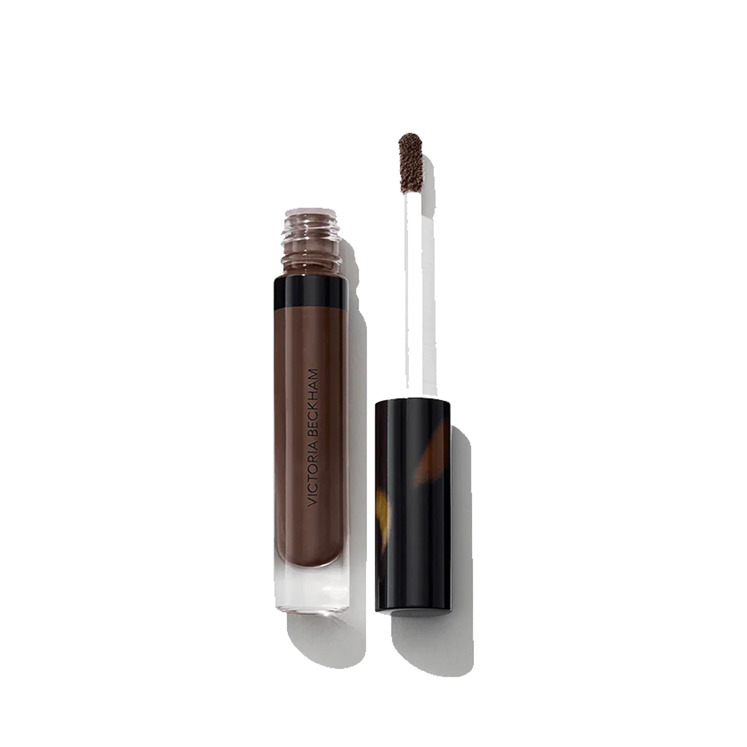 A tube of lip gloss with applicator out of tube