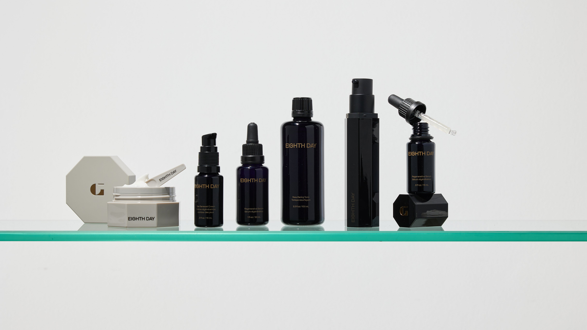 Eighth Day skincare in black bottles and jars on a glass shelf
