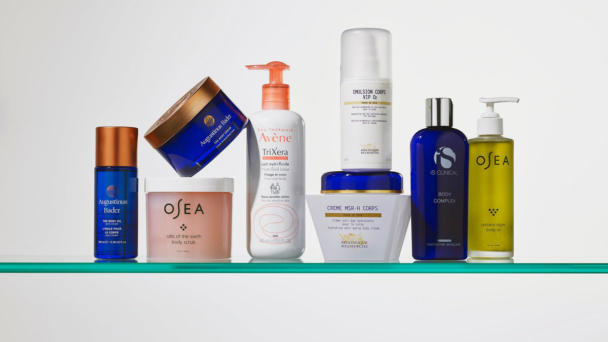 Body creams, lotions and oils arranged on a glass shelf