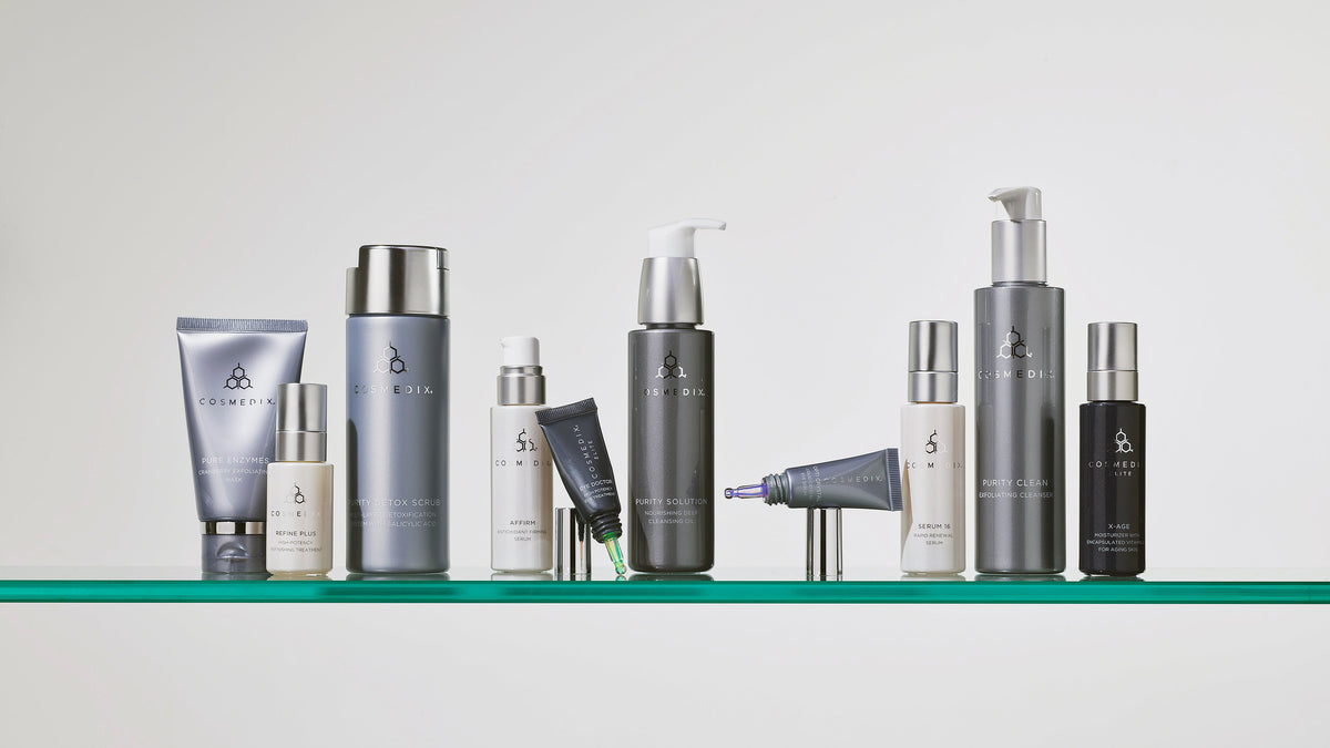 CosMedix tubes, pumps and treatment bottles arranged on a glass shelf
