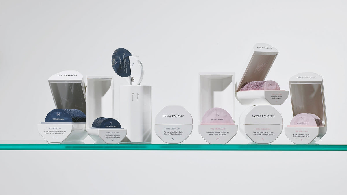 Noble Panacea geometric skincare packaging and individual doses on a glass shelf