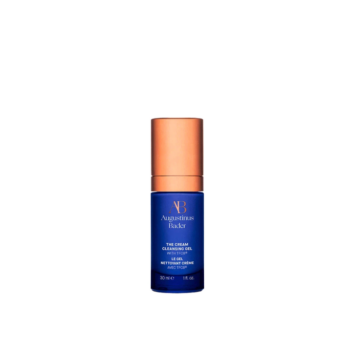 A bottle of Augustinus Bader The Cream Cleansing Gel - 30ml with a blue label and copper cap.