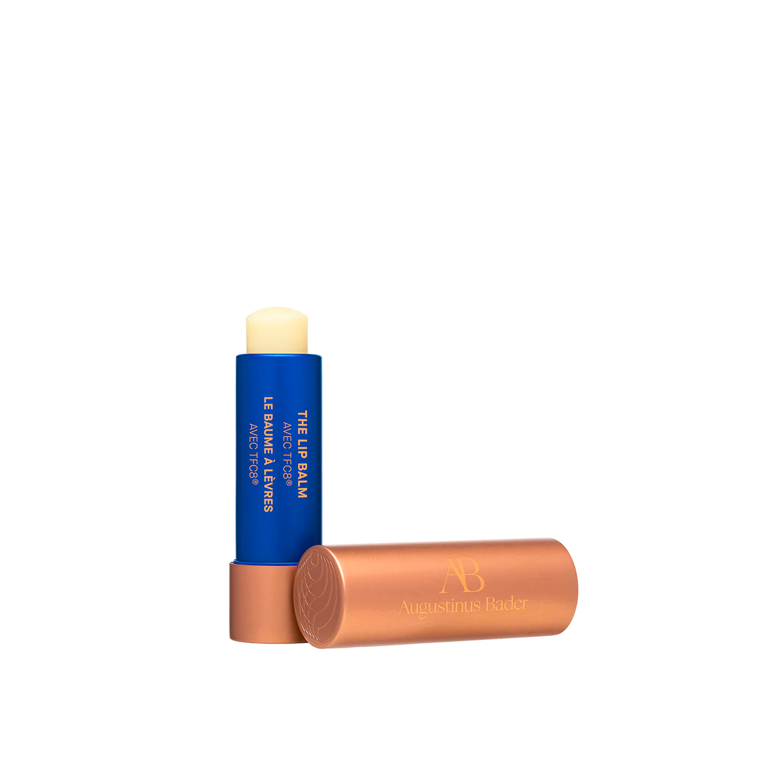 A stick of Augustinus Bader The Lip Balm with the cap removed, revealing the product.