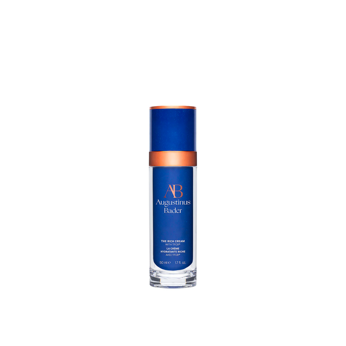 A blue and white bottle of Augustinus Bader The Rich Cream with a copper-colored cap.