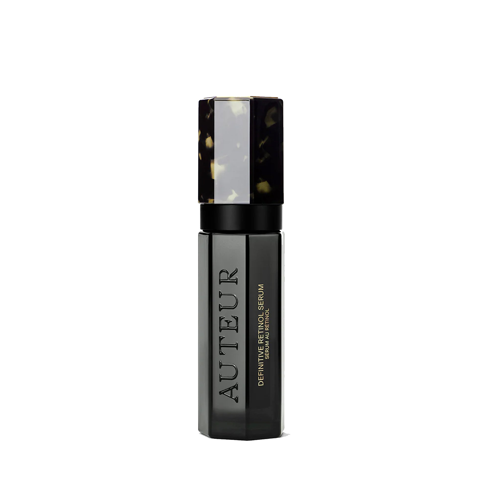 A bottle of Auteur Definitive Retinol Serum with a black and patterned cap, labeled with the brand's logo.