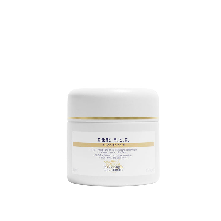 White jar of Crème M.E.C. with gold accents on a white background