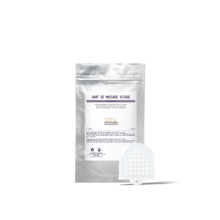 A packaged Biologique Recherche facial massage glove, with the product visible in front of the package.