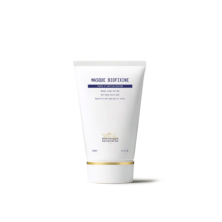 A tube of Biologique Recherche Masque Biofixine with a white and blue label, indicating it is a deeply regenerative facial mask treatment.