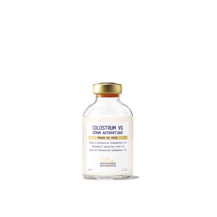 A glass vial labeled 'COLOSTROUM VG' by Biologique Recherche, indicating it is a skincare serum.