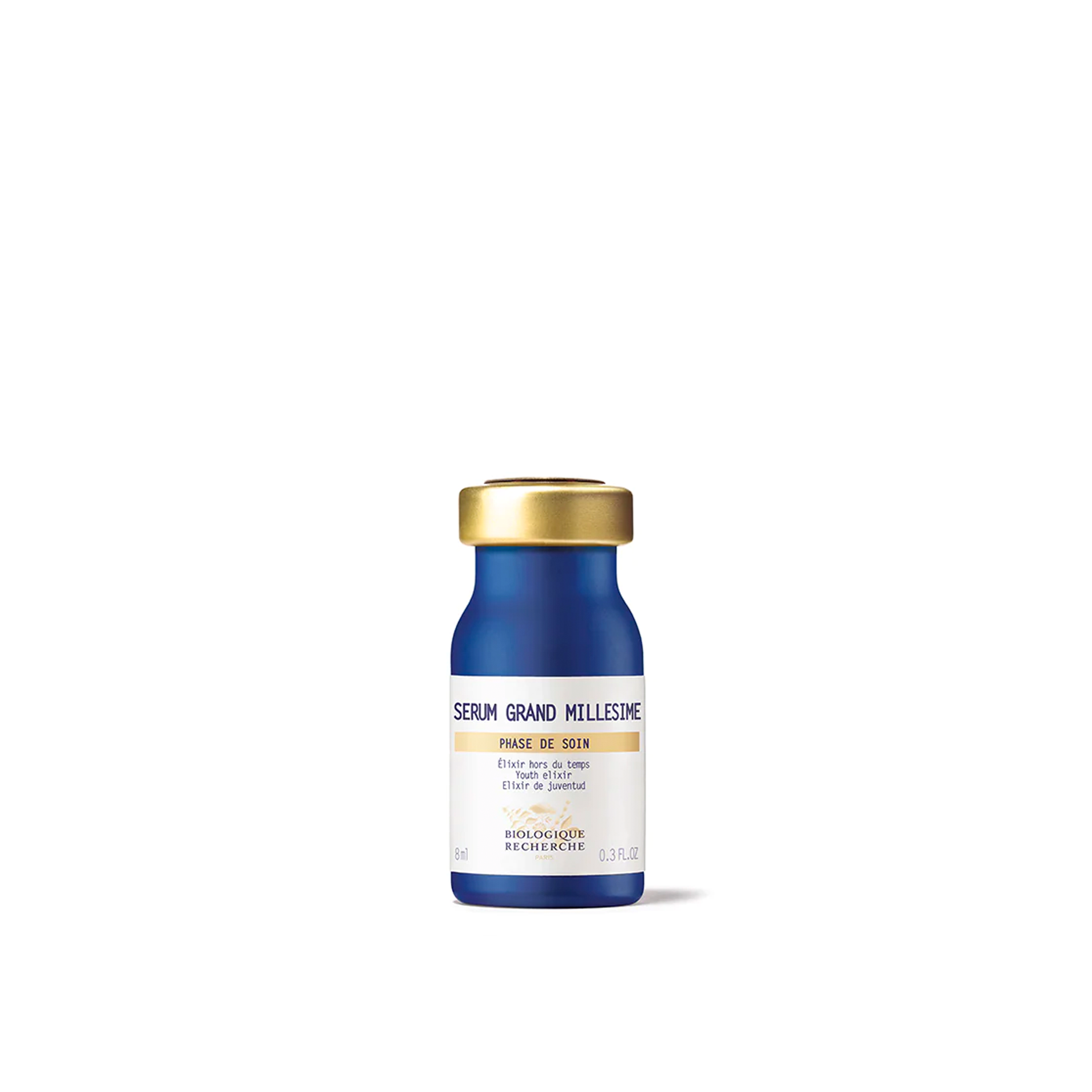 A bottle of Biologique Recherche Serum Grand Milliesime with a blue body and a gold cap.