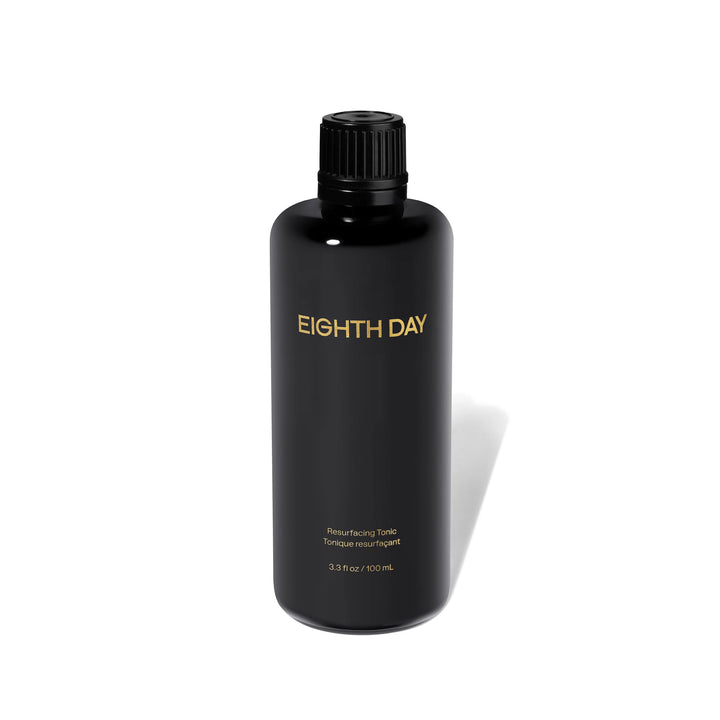 Black bottle of Eighth Day product on a white background