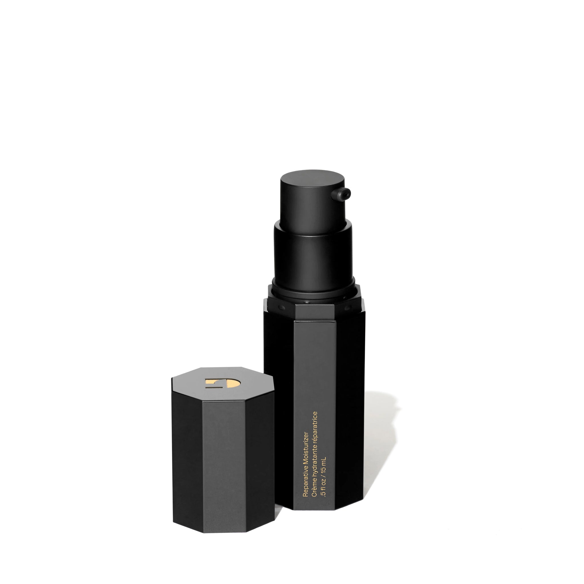 Black cosmetic bottle and cap on a white background