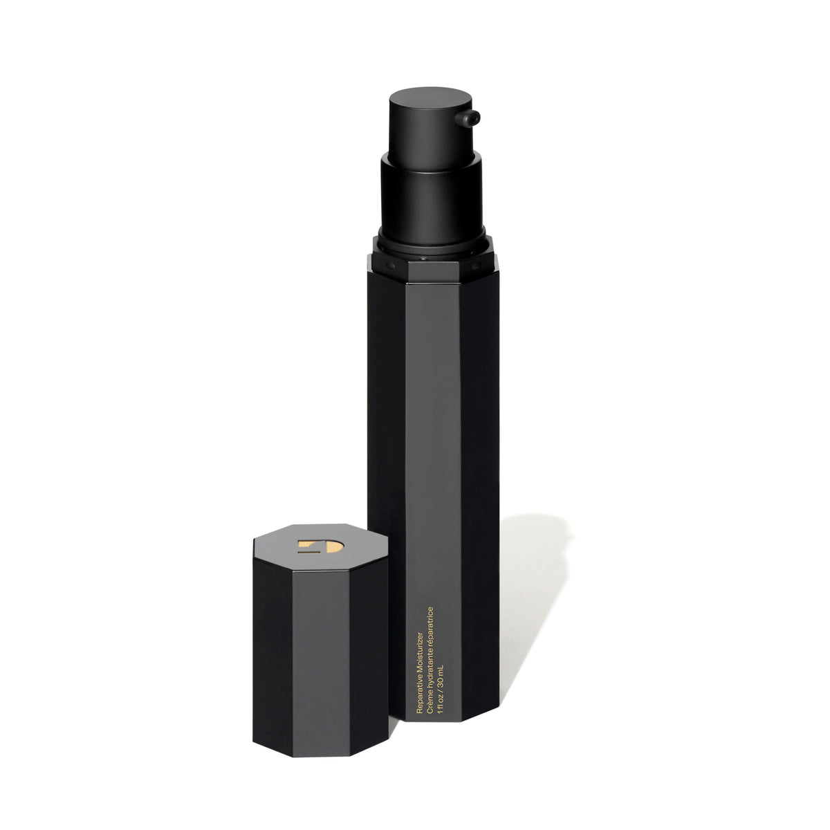 Black cosmetic bottle with hexagonal cap on a white background