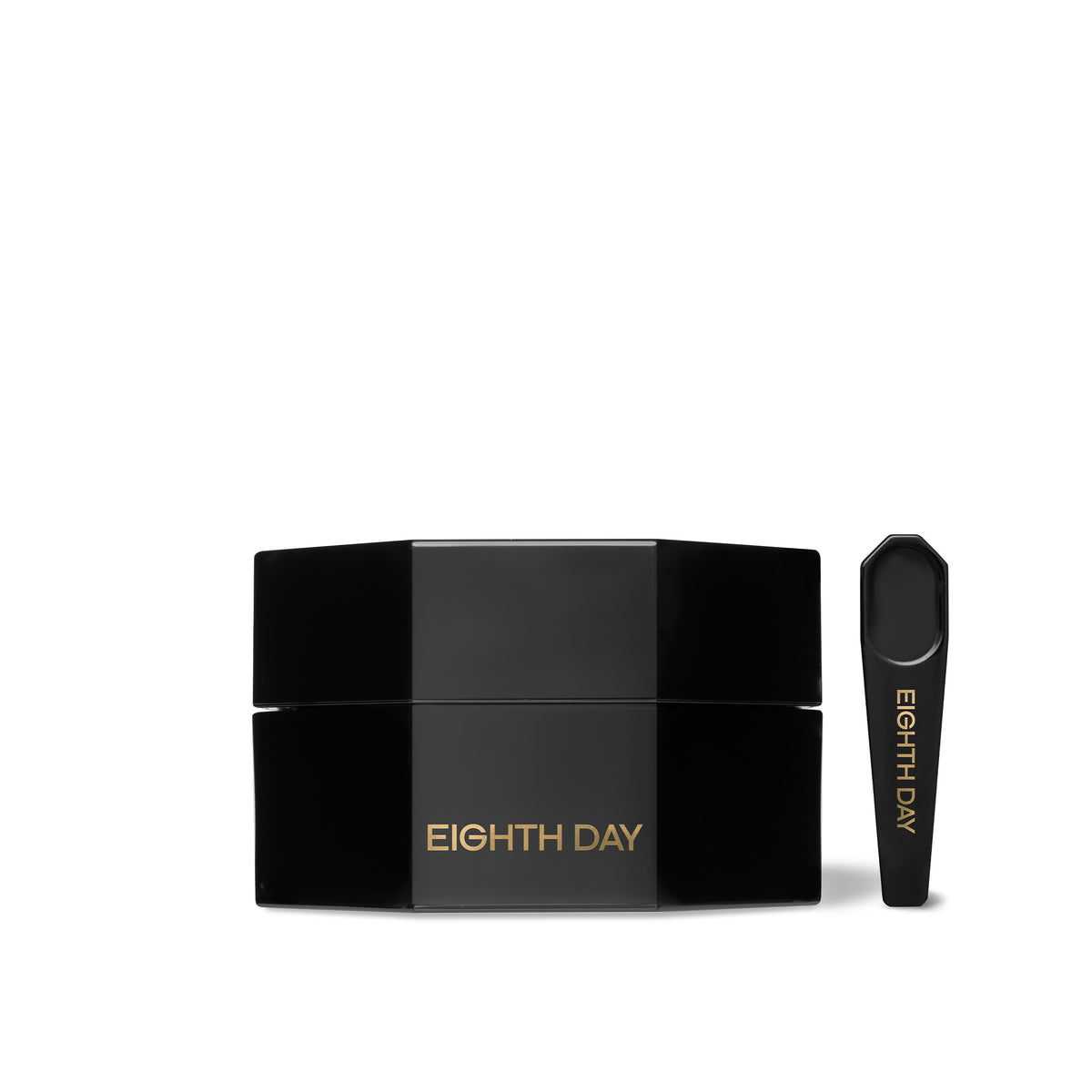 A black jar with a small spoon on the side, labelled with Eighth Day, indicating it is a skin care product.