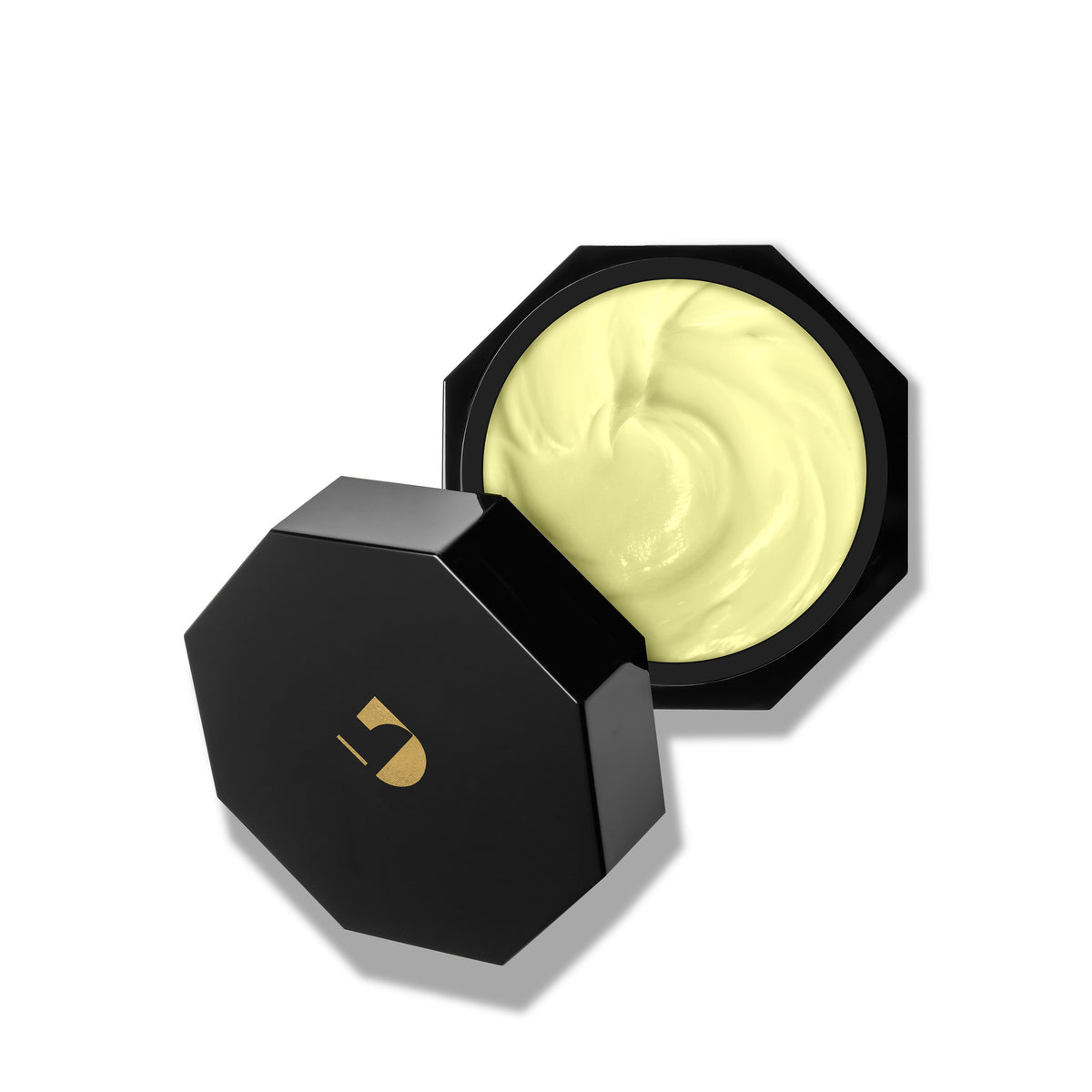 A jar of night cream displaying the contents with the lid off
