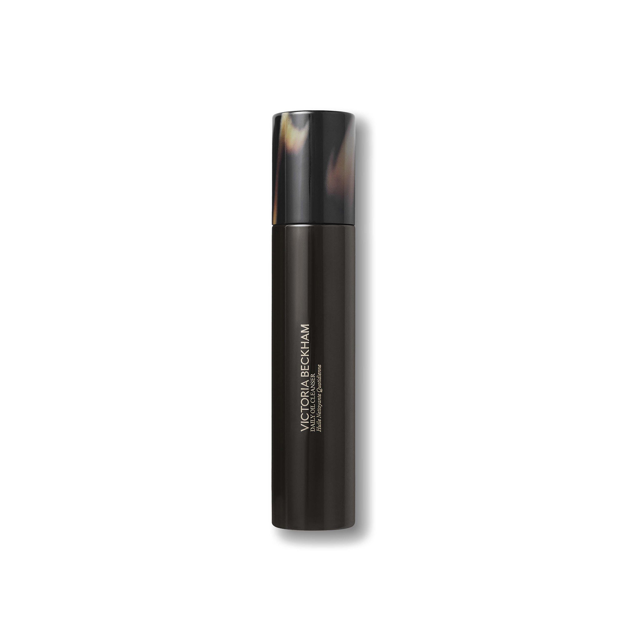 Black cosmetic bottle with tortoiseshell cap on a white background
