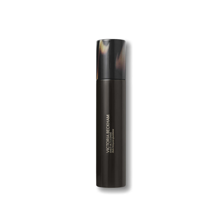 Black cosmetic bottle with tortoiseshell cap on a white background