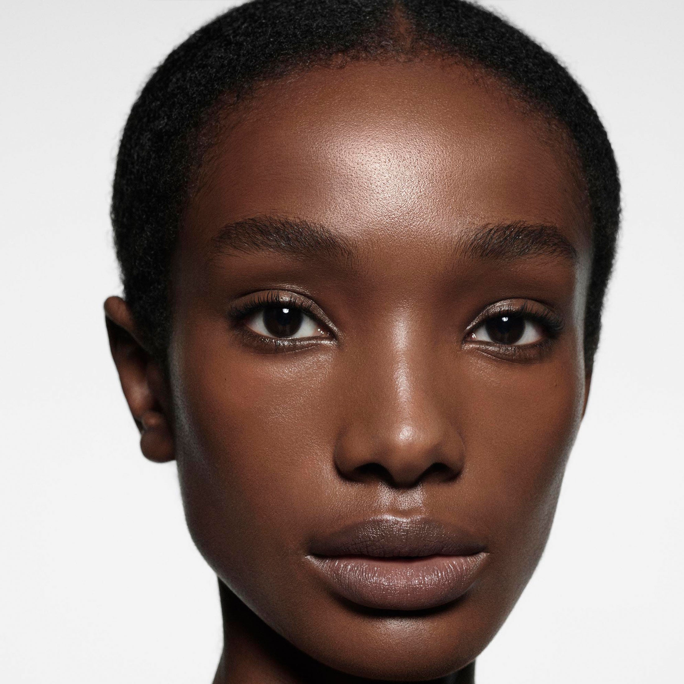 Close-up of a person with a neutral expression on a white background