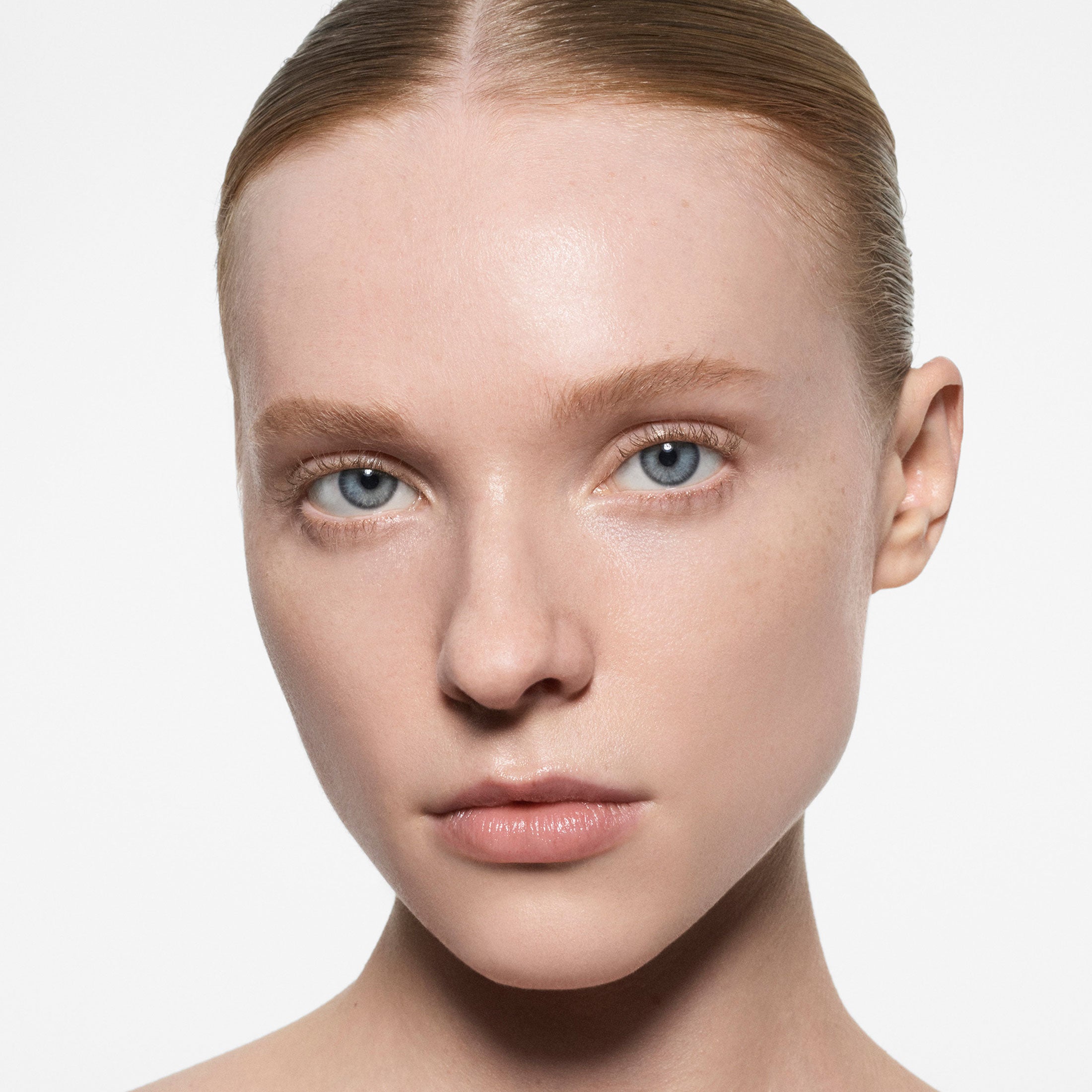 Close-up of a person with a neutral expression on a light background