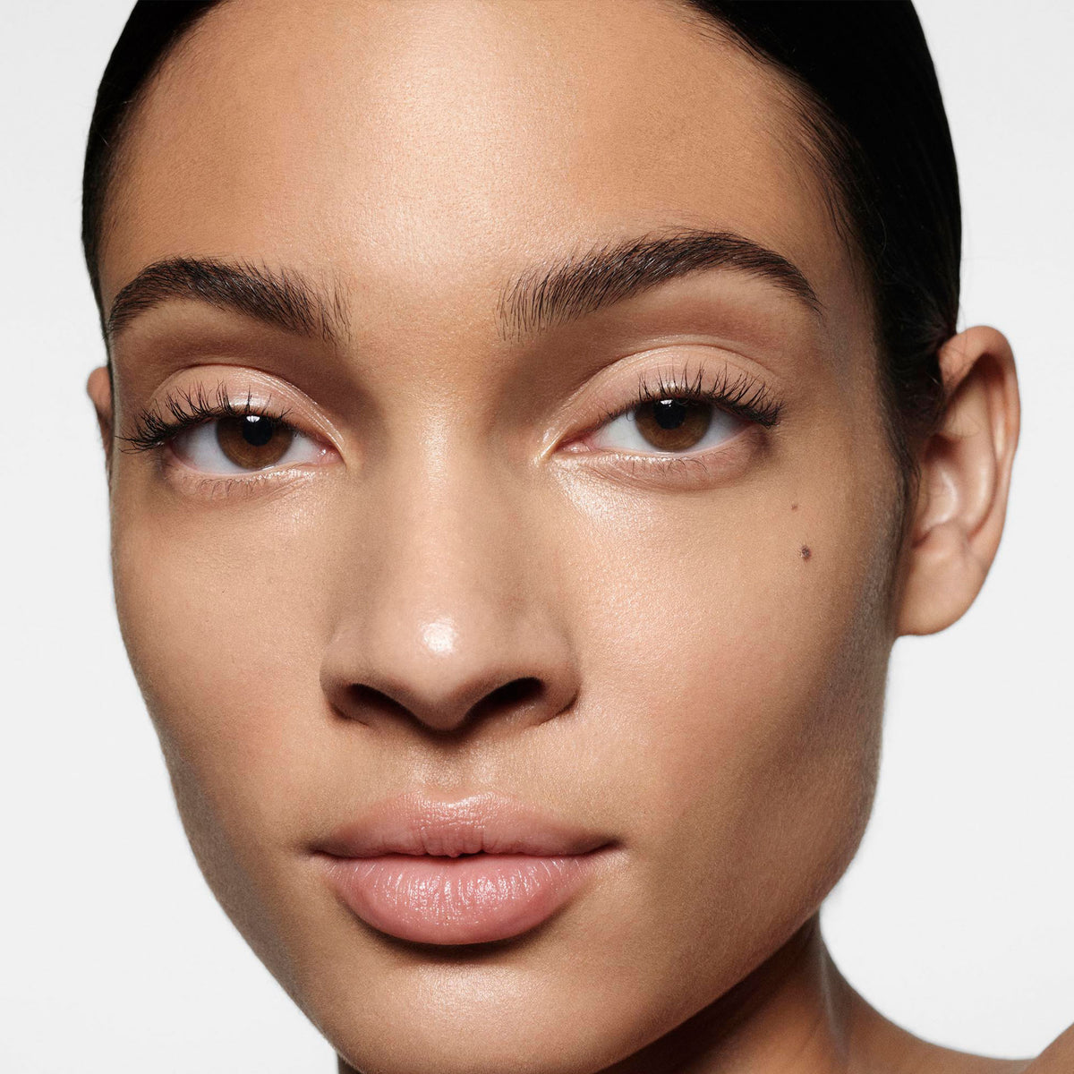 Close-up of a person's face with a neutral background
