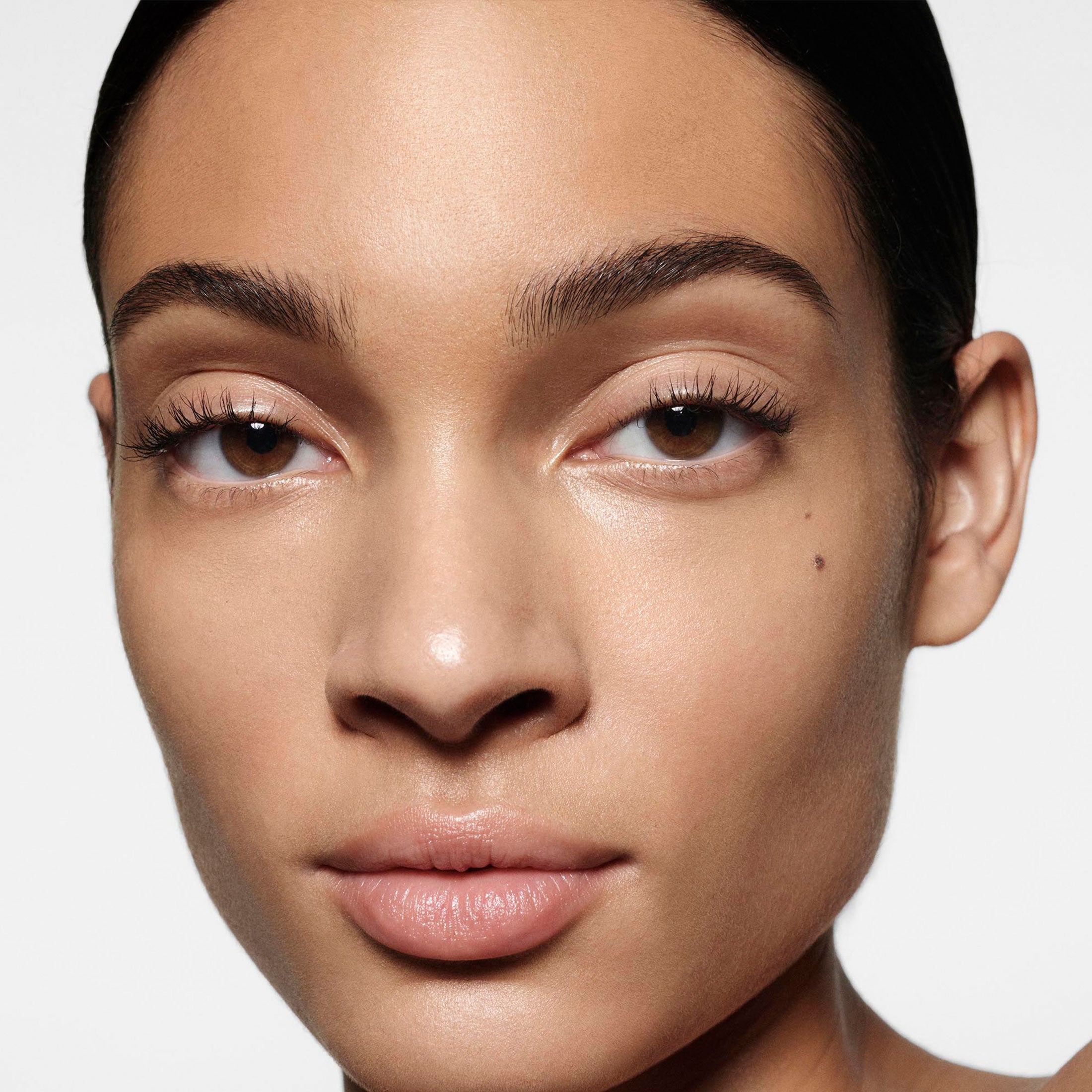 Close-up of a person's face with a neutral background