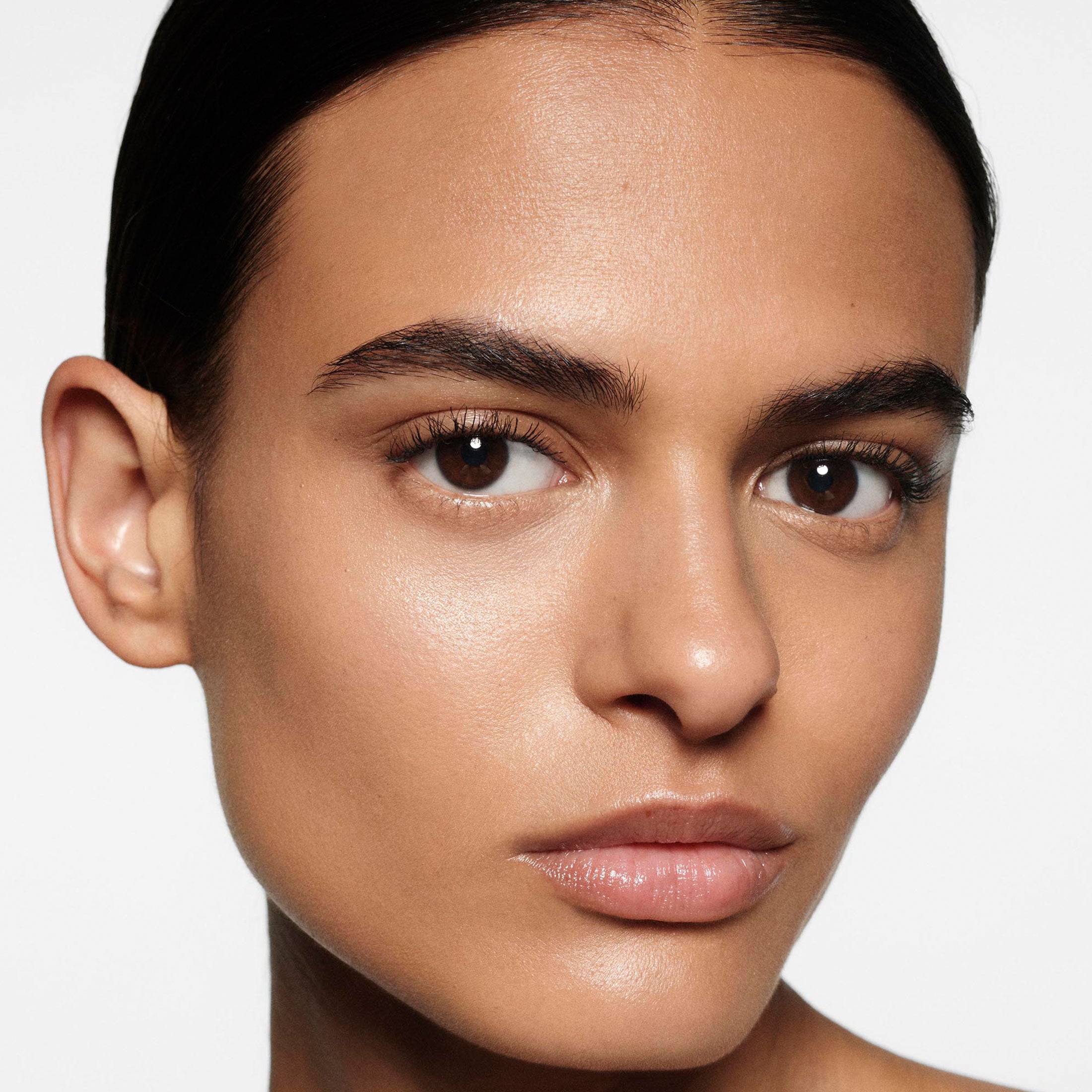 Close-up of a woman's face with a neutral background
