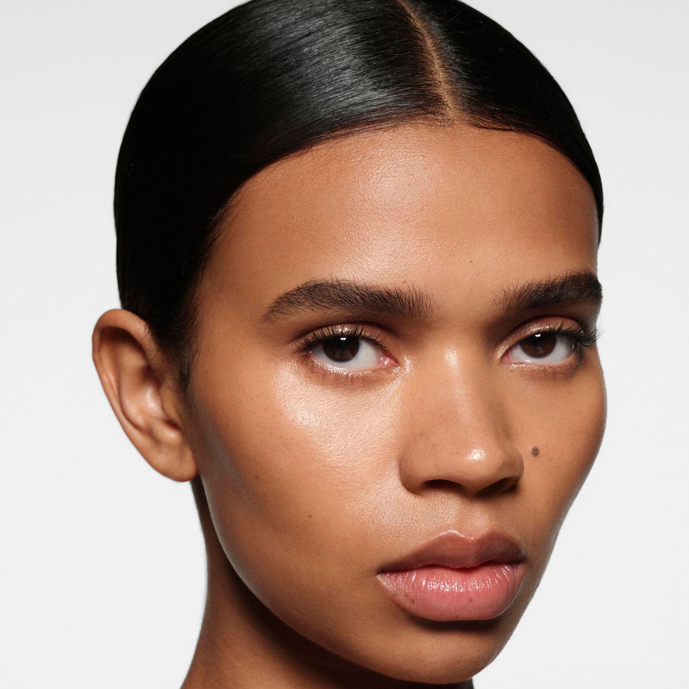 Close-up of a woman's face with a neutral background