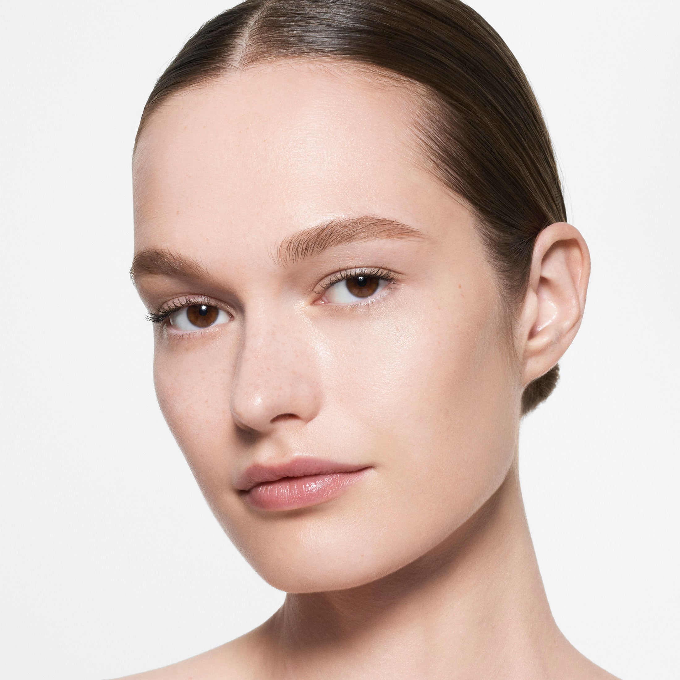 Close-up of a person with a neutral expression on a plain background