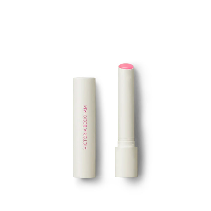 Victoria Beckham Beauty Posh Balm in Fleur, a lip balm with a white bullet dispenser