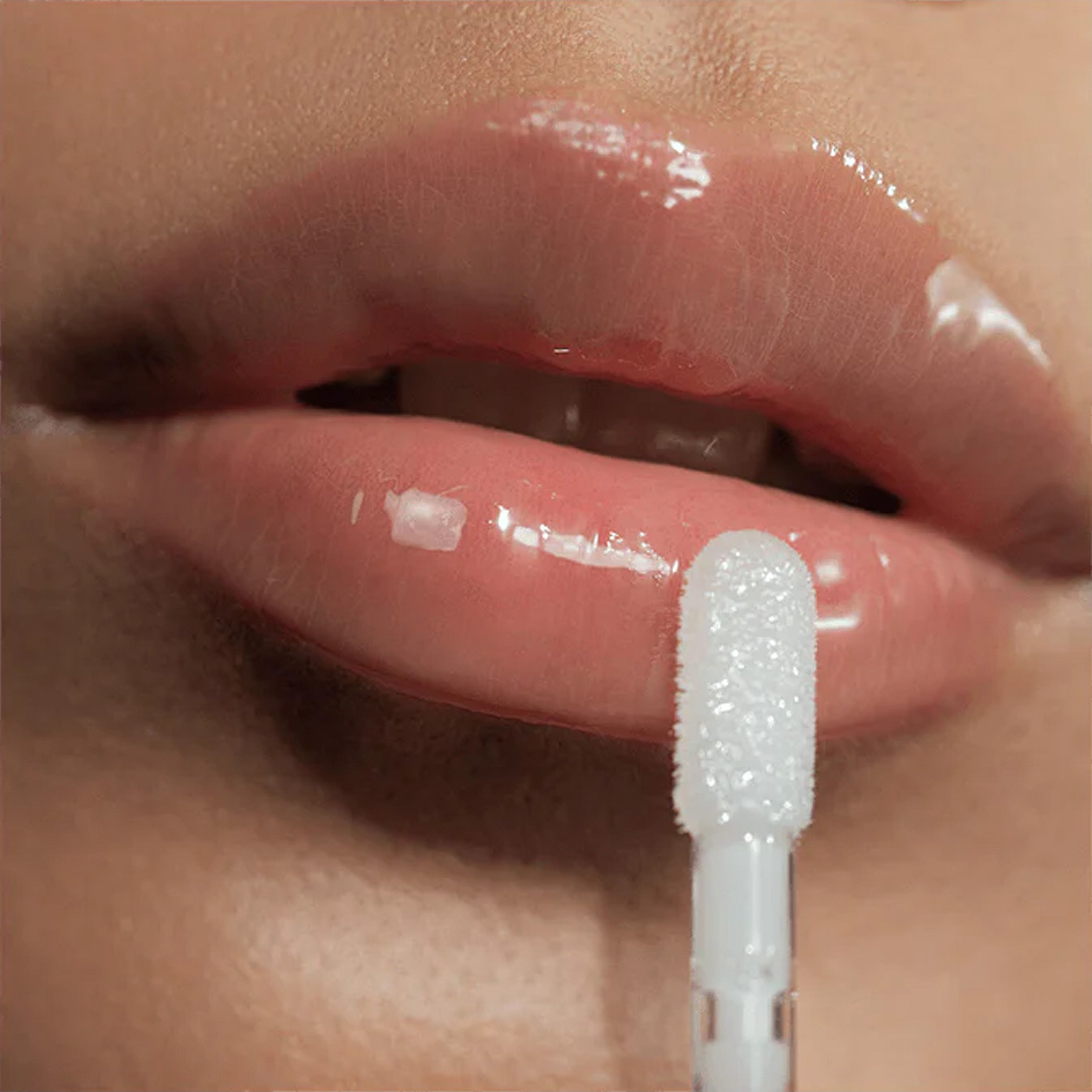 A close up image of lips wearing Victoria Beckham Beauty Posh Gloss in Ice