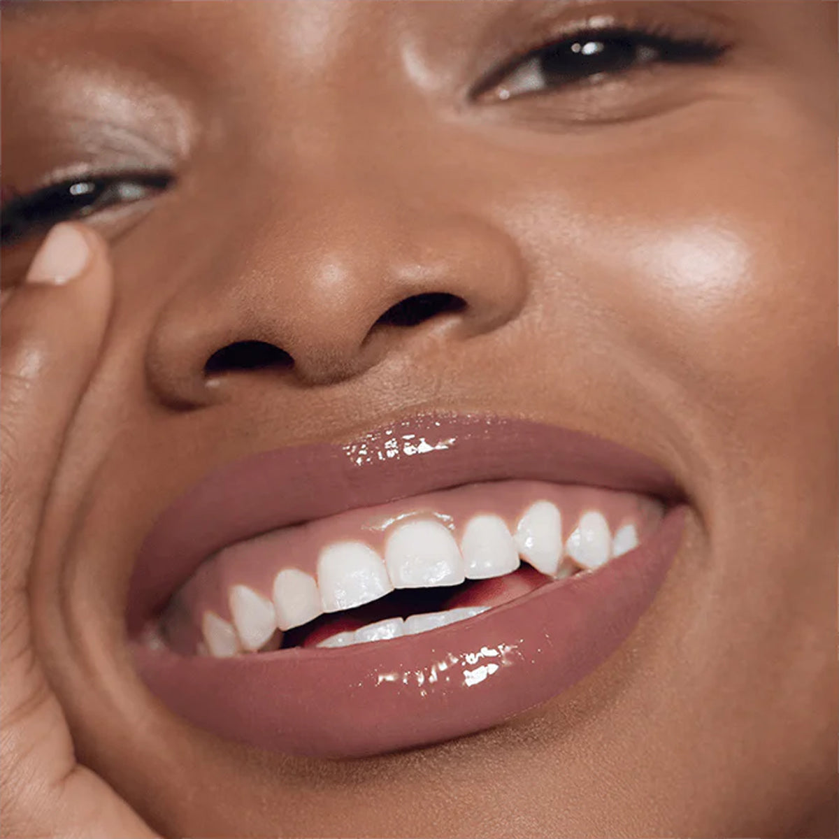 A close up image of model wearing lip gloss