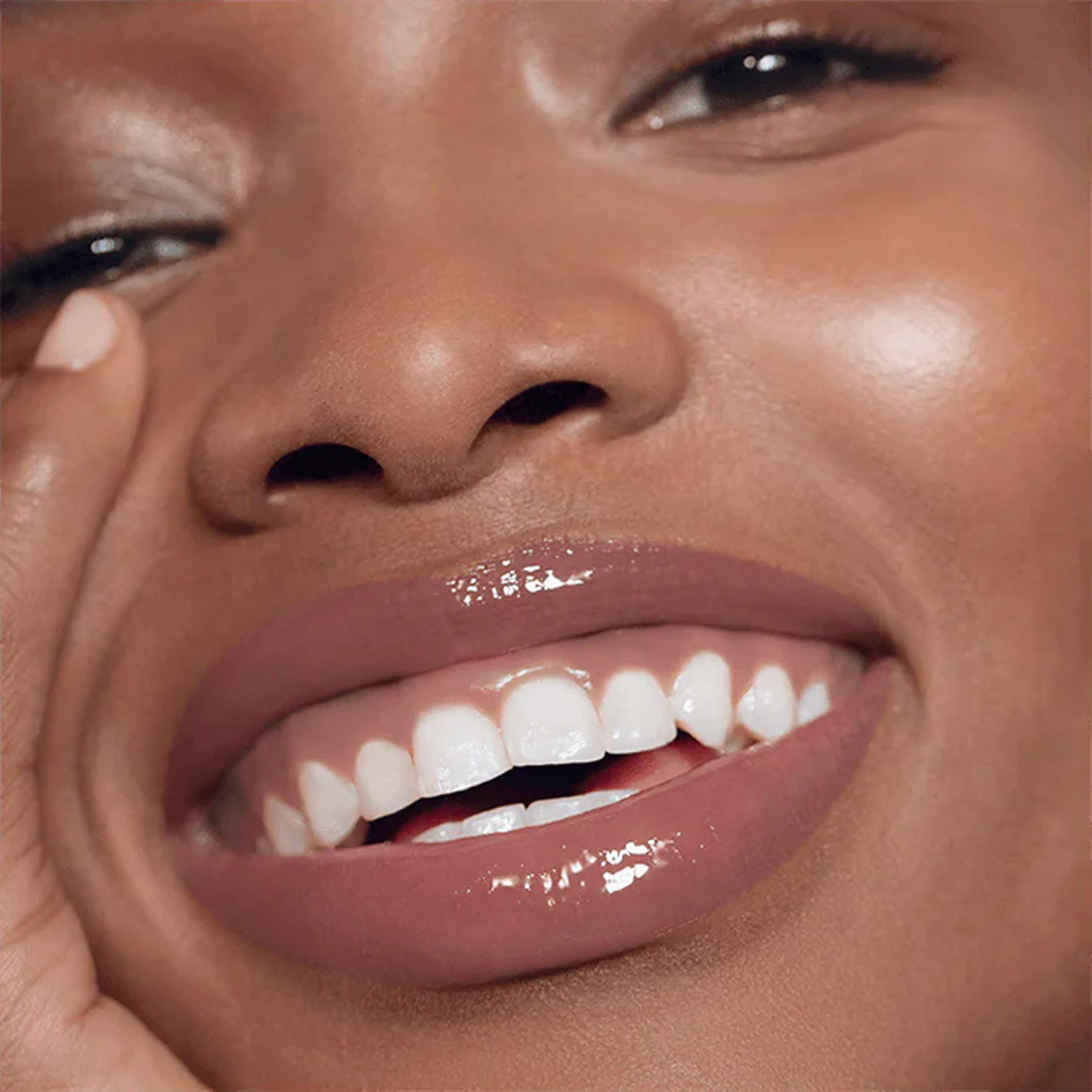 A close up image of model wearing lip gloss