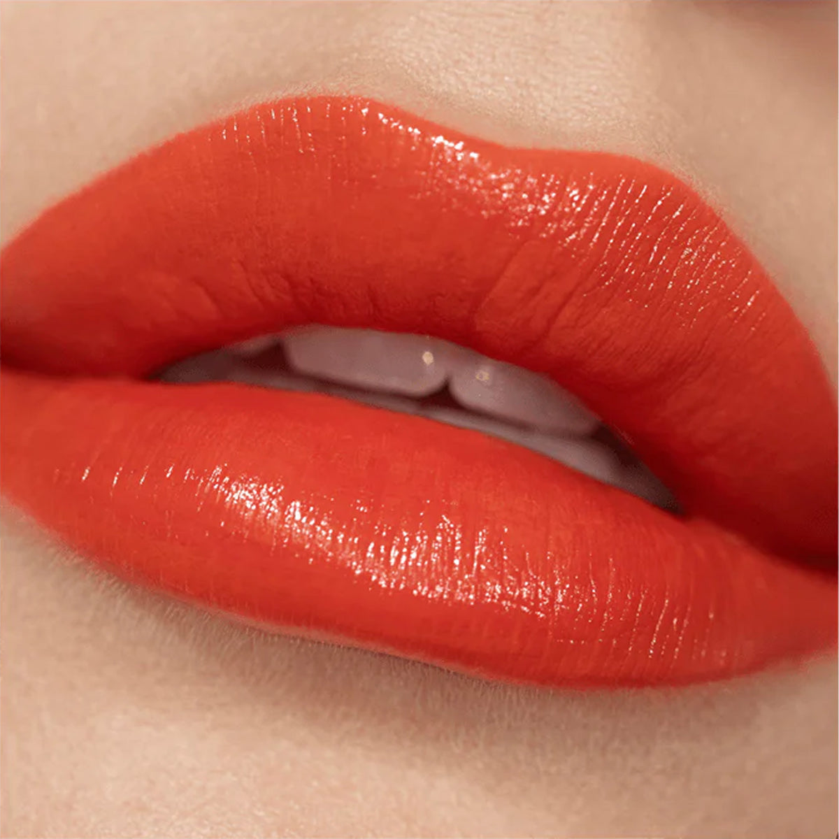 A close up image of lips wearing red lipstick