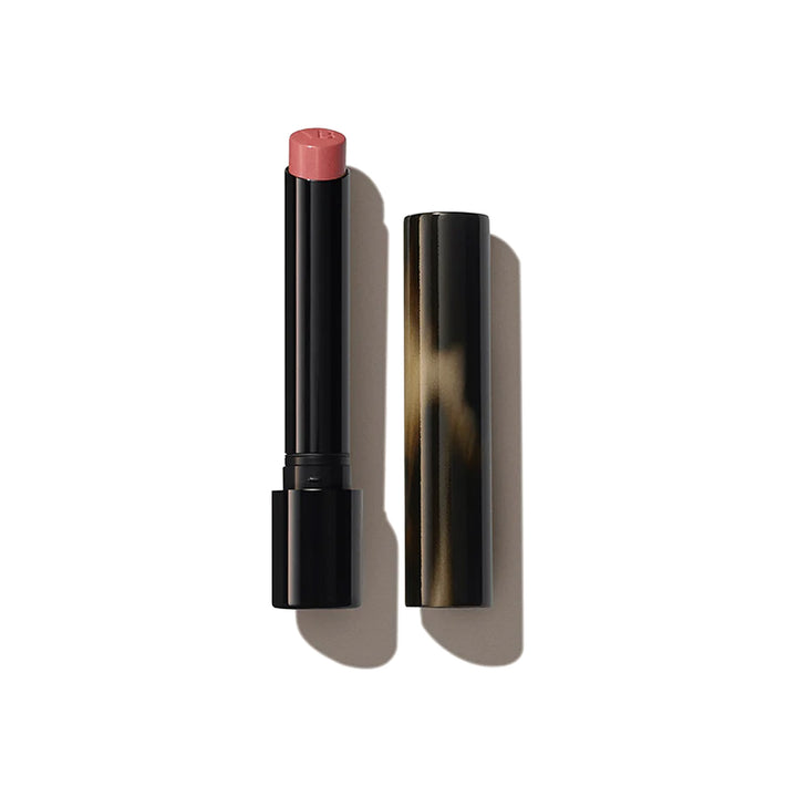 A Victoria Beckham Beauty Posh Lipstick in the shade 'Pout', with the cap removed, showing a coral pink colour.