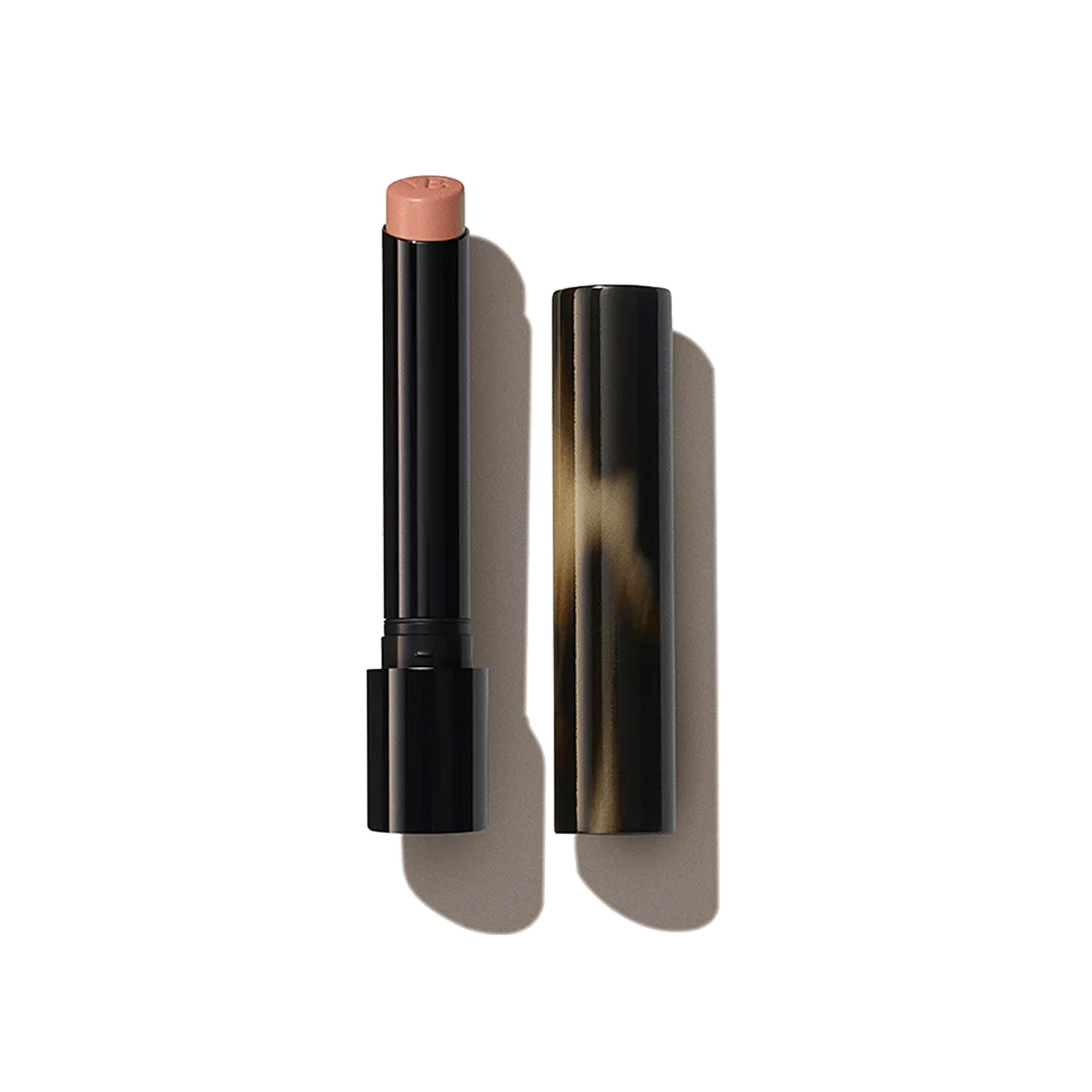 A Victoria Beckham Beauty Posh Lipstick in the shade 'Smile', with the cap removed, showing a pale peach colour.
