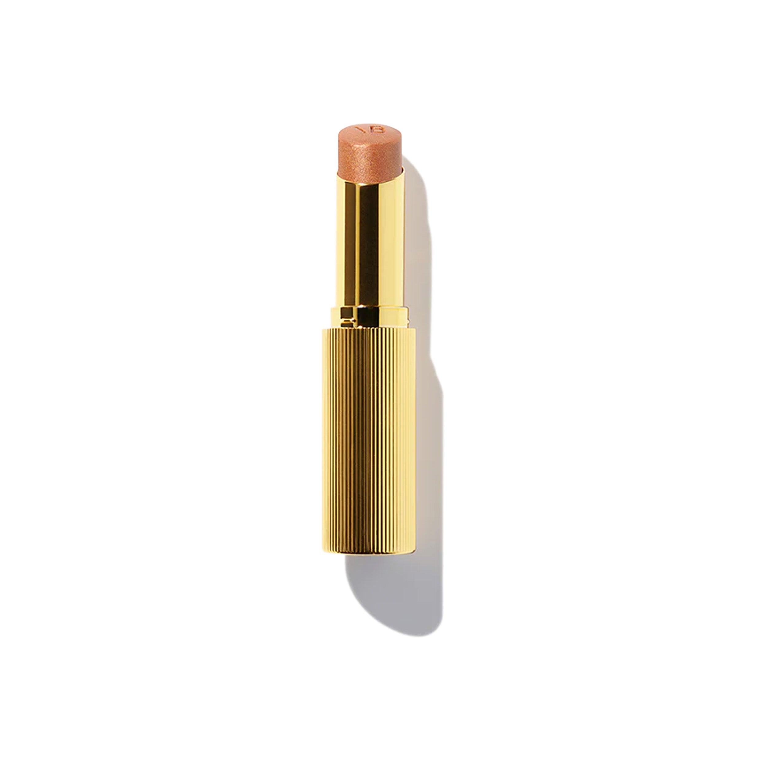 A gold designer case containing a highlighter stick with a bronze color tone.