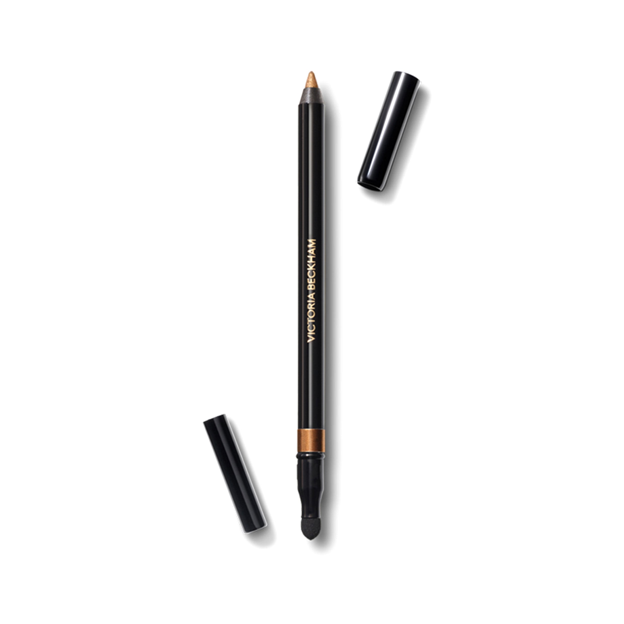 A bronze-colored Victoria Beckham Beauty Satin Kajal Liner pencil with the cap off, showing the golden brown shade with shimmer.