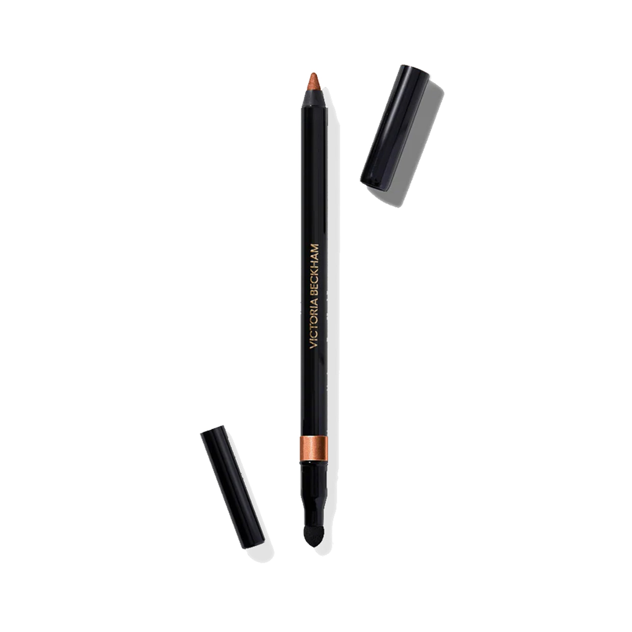A Victoria Beckham Beauty Satin Kajal Liner in color Copper, with the cap off, showing the shimmery reddish brown eyeliner pencil and the smudger on a white background.