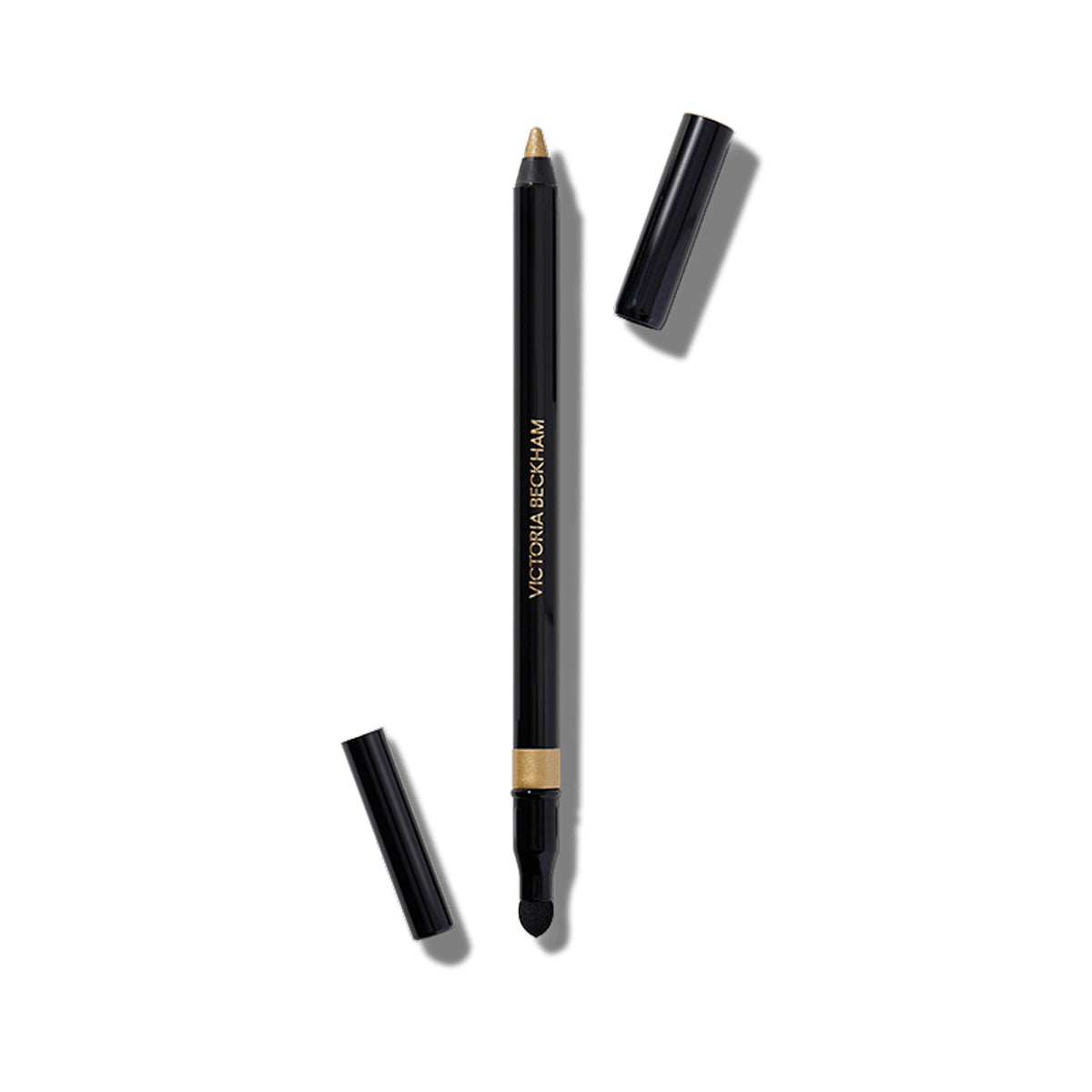 A gold-colored eyeliner pencil capless, showing the actual gold lead tip, with the brand name 'Victoria Beckham Beauty' on the side.