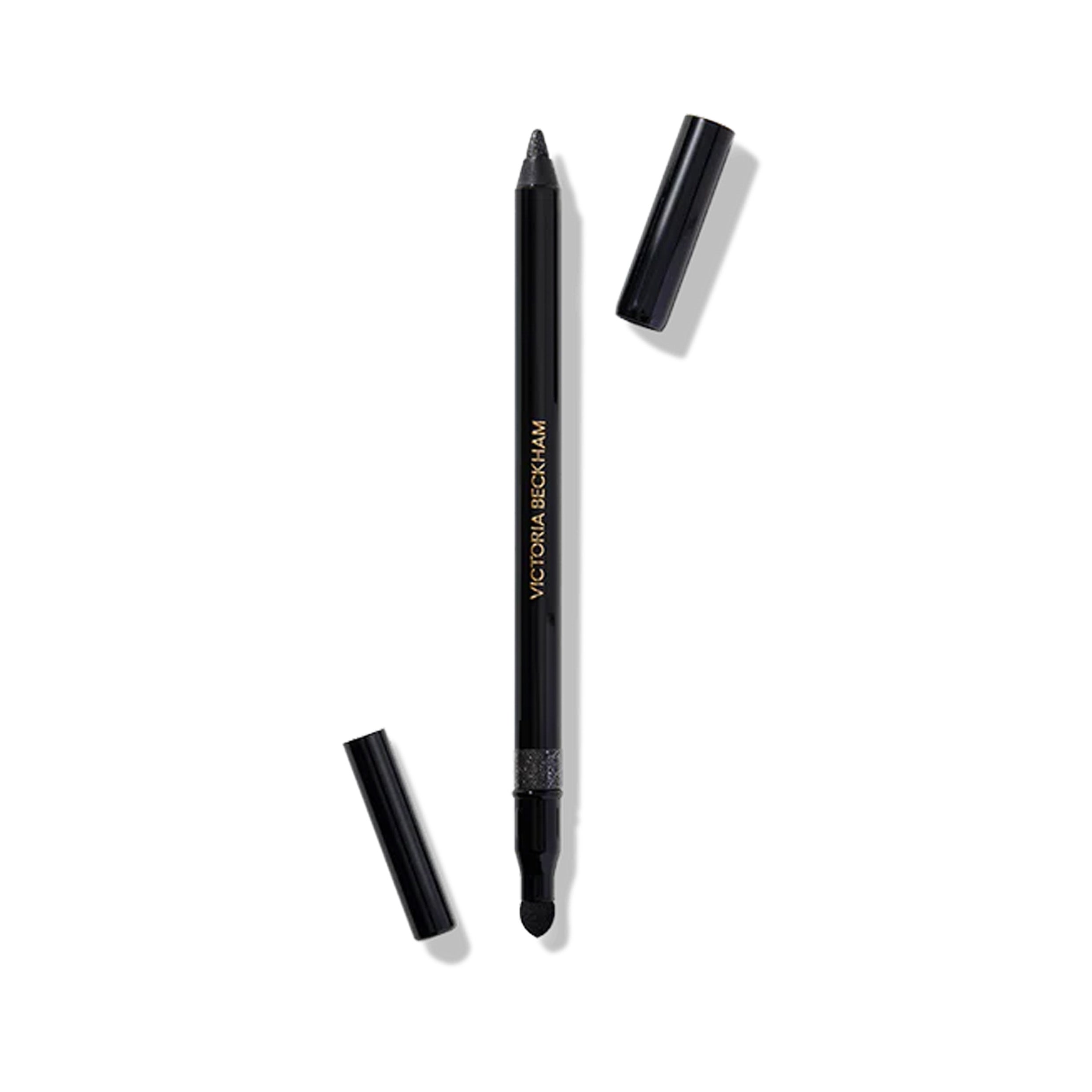 A Victoria Beckham Beauty Satin Kajal Jewel Liner in color Night Flash, with the cap off, showing the slate black with silver sparkle eyeliner.