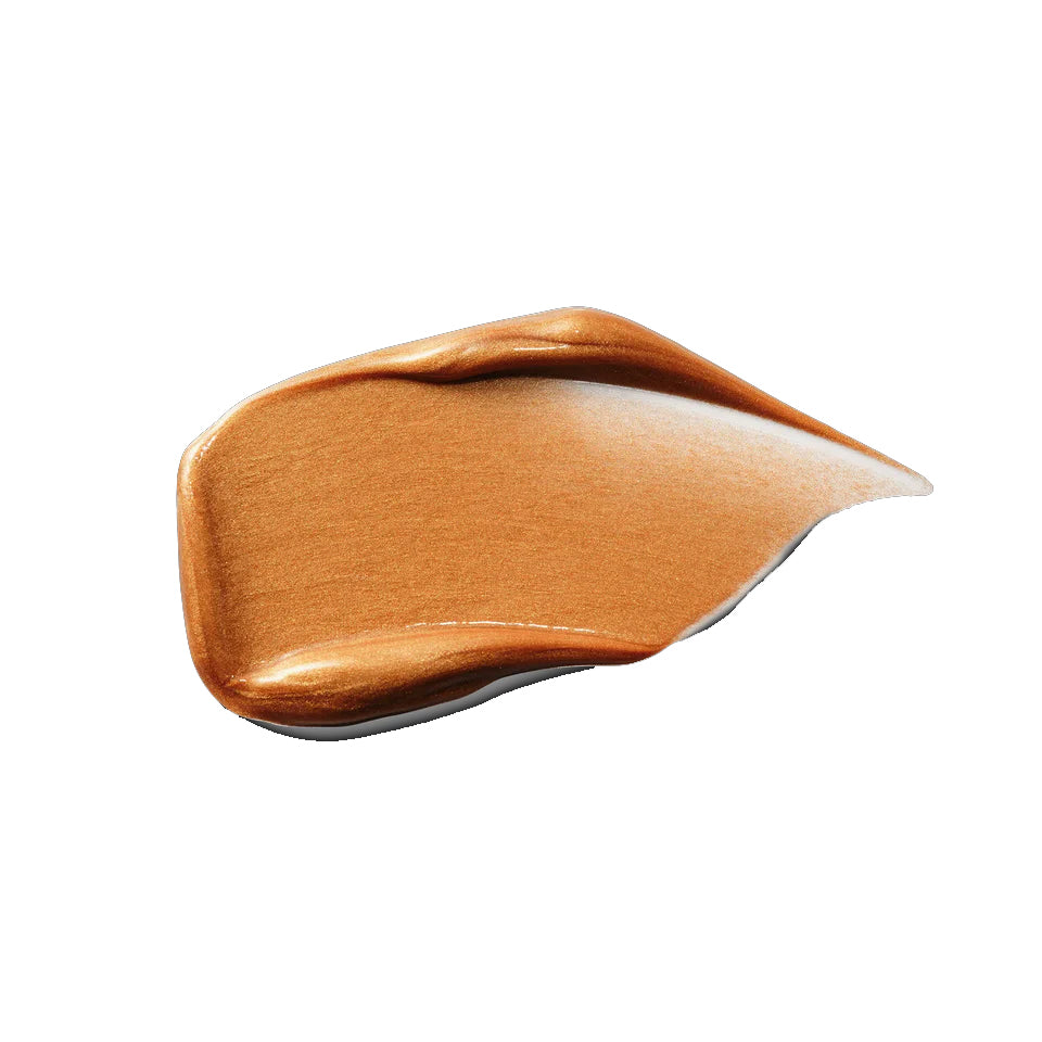 Swatch of brown makeup cream on a white background