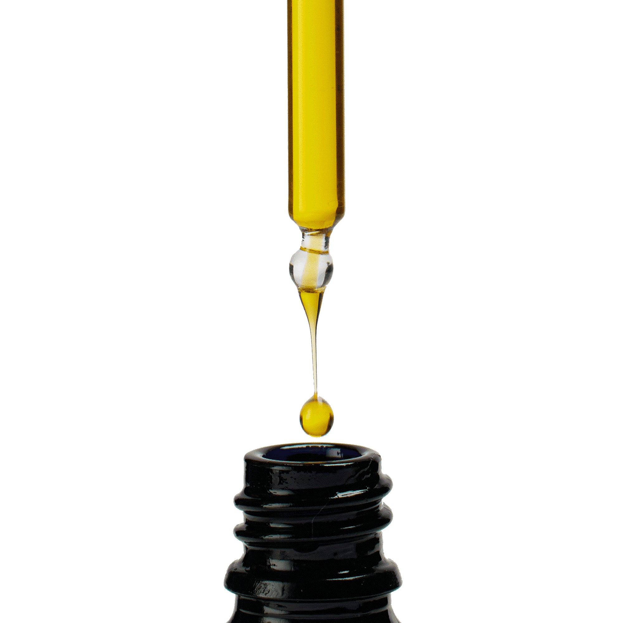 Yellow liquid being dripped from a dropper into a black container on a white background